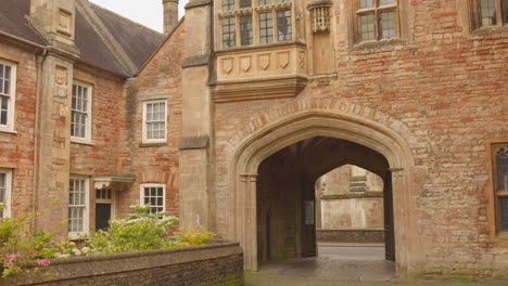 historic brick archway entrance at vicar's close in wells, england, the oldest residential street