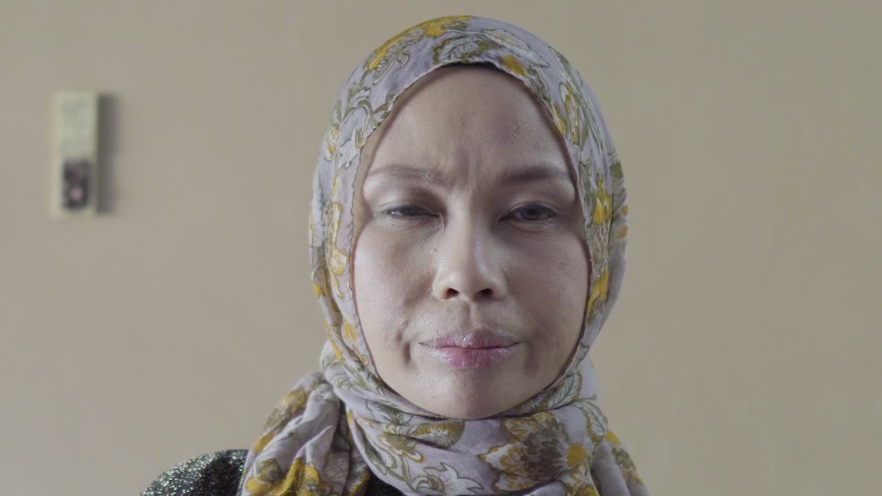 Muslim Woman looking slightly disappointed into camera ZOOM IN