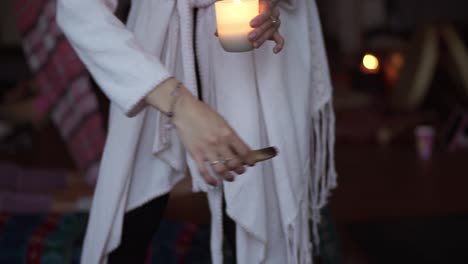 ceremonia de incienso, mujer irreconocible quemando palo santo en una habitación llena de gente