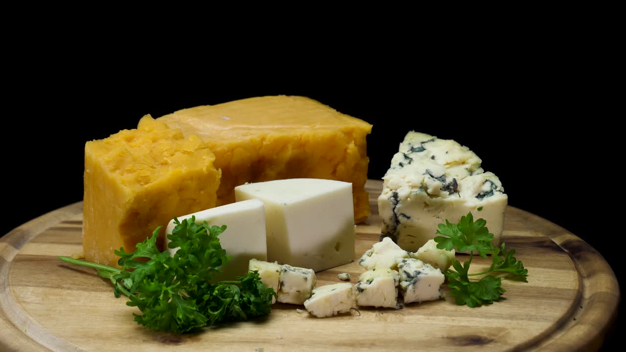 Assortment of Cheeses on Wooden Board