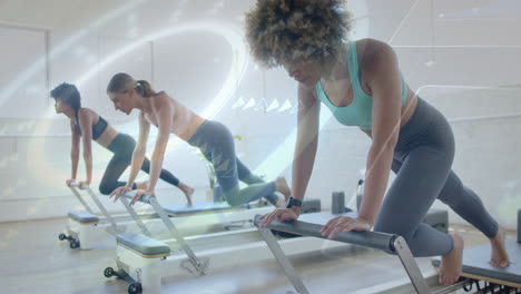 women exercising on reformer machines with digital fitness data overlay animation