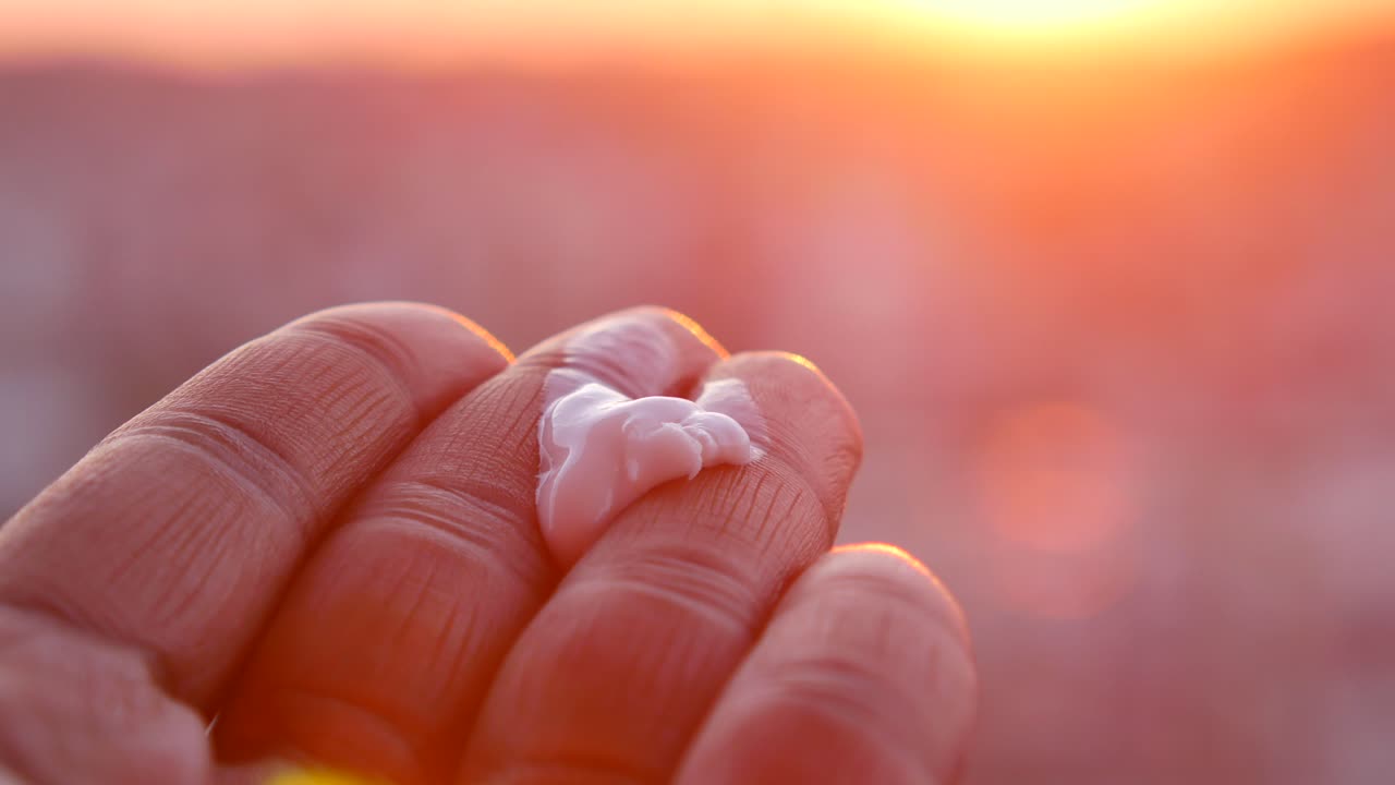 Sunscreen on hand at sunset