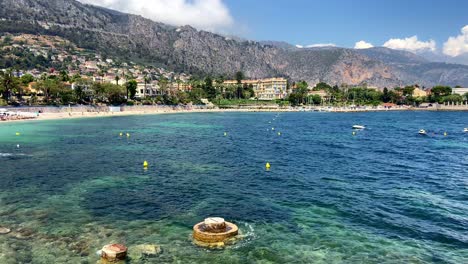 Walking-In-The-Promenade-Of-Plage-des-fourmis-With-Panorama-Of-Blue-Sea-and-Beachfront-Resort-In-Beaulieu-sur-Mer,-France