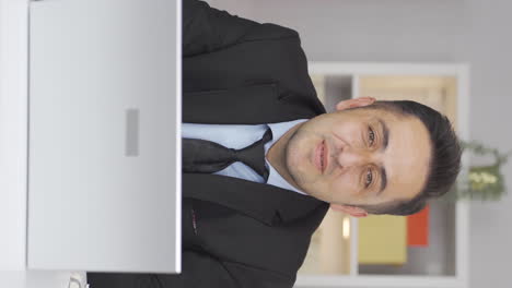 vertical video of home office worker man talking facetime looking at camera.