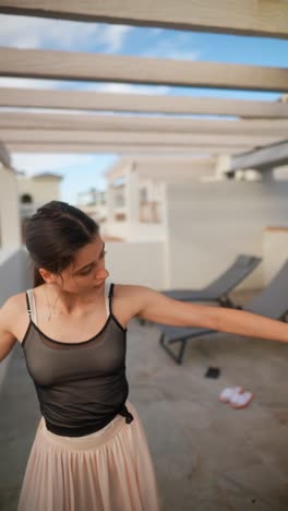 young woman dancing on a balcony