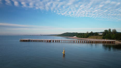 scenic aerial riser at sunrise of wooden gdynia orlowo pier in bay of gdansk