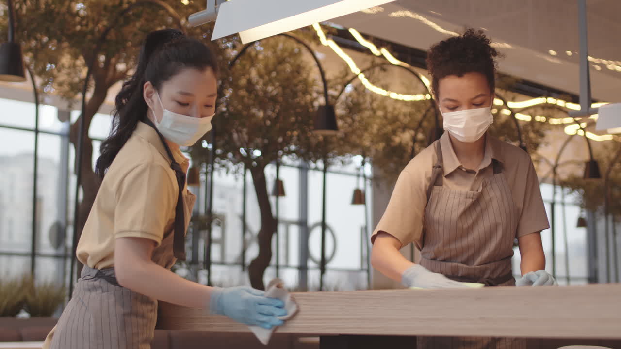 Diverse Women Wiping Cafe Table