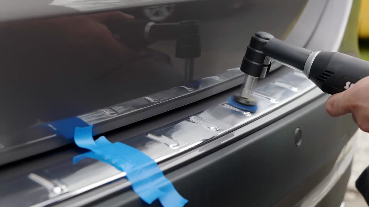 Polishing chrome silver bumper trim with nano machine polisher and blue pad - close up