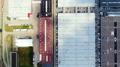 Aerial footage of a large shopping centre and car parks located in the city