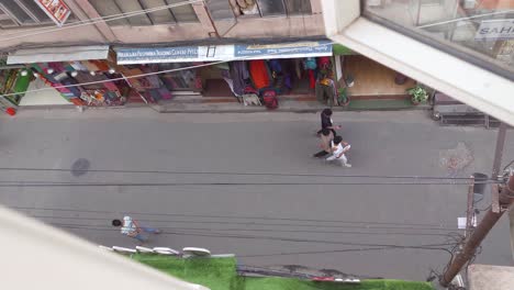 thamel, kathmandu, nepal - people strolling through the bustling, narrow streets of thamel lined with vibrant stalls and shops - aerial topdown shot