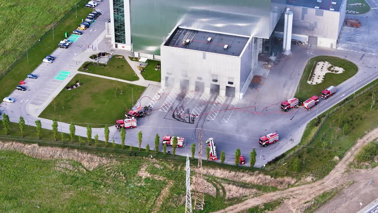 Aerial view of Kaunas cogeneration plant as firefighters respond to an emergency. Action-packed urban-industrial footage