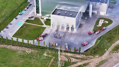 aerial view of kaunas cogeneration plant as firefighters respond to an emergency. action-packed urban-industrial footage