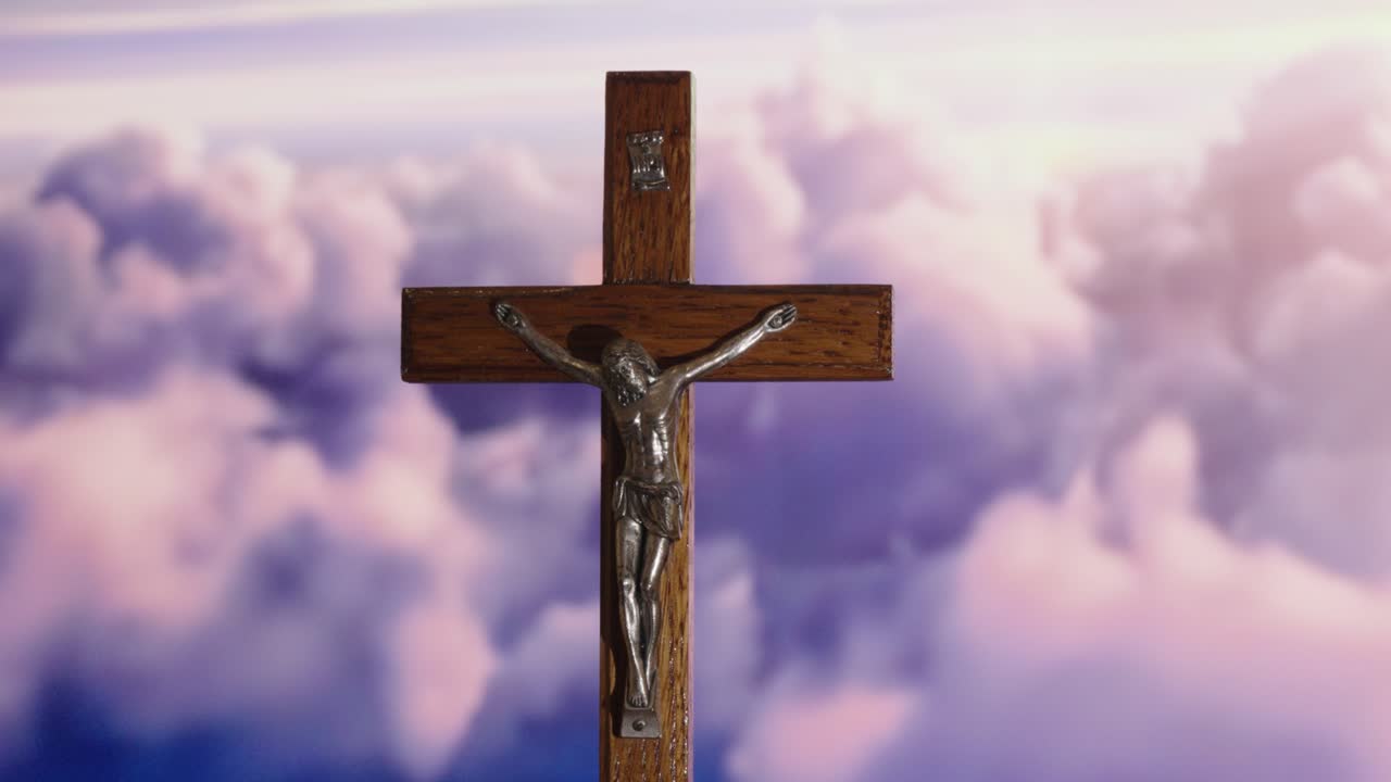 Wooden Crucifix with Jesus Against a Serene Sky - Symbol of Faith and Peace