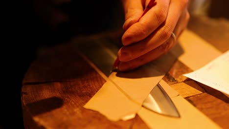 hands folding paper into an airplane shape