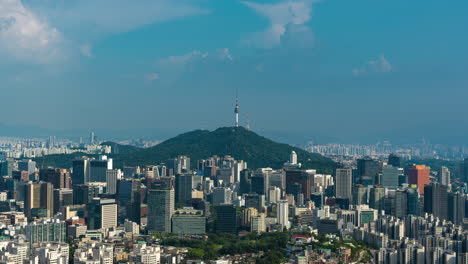 zooming out from iconic n seoul namsan tower revealing majestic aerial city urban panorama of downtown seoul in golden hour - time lapse