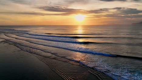 drone clip showing surfers paddling through perfect point break at g-land, java, indonesia at sunset