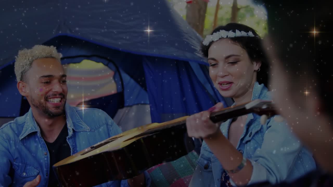 Woman reaching guitar lifting neck offering guitar tapping for music at camp sparkles overlay