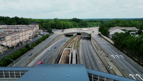 forwards tracking of subway train passing under road bridge on multilevel road intersection