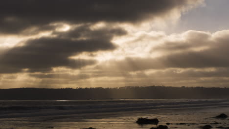 waves break in slow motion on coronado, california, beach at sunset, wide shot