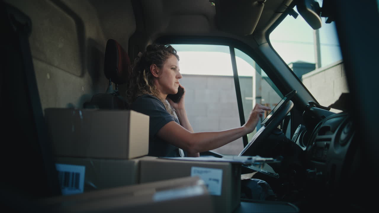 Woman Working in a Delivery Van, Handling Packages and Communications