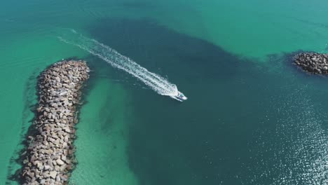 small boat entering marina from open sea 4k 50fps