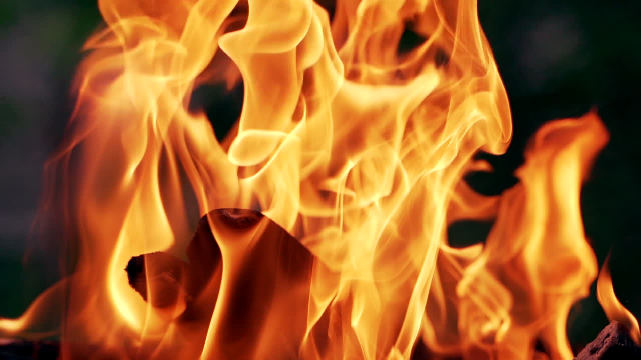 Bonfire. Burning logs in orange flames. Beautiful fire burns brightly. Slow motion