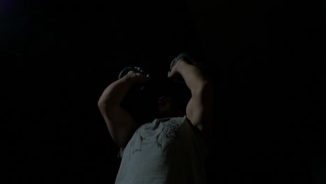 man performing kettlebell overhead press