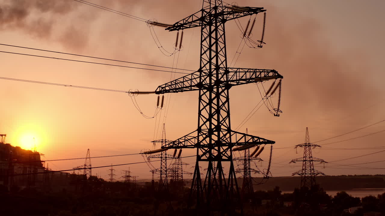Electricity tower with wires at sunset. Tall pylon carries wires that transport electric power from generating stations to electrical substations against the evening sky.
