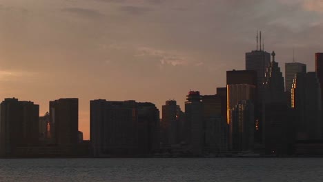 the camera pans the skyline of toronto and ends with the cntower and a pastel sky