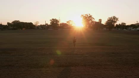 indian guy running and trainning for cardio exercise on public park during sunset
