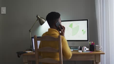 Afroamerikanische-Frau-Spricht-Auf-Dem-Smartphone,-Während-Sie-Von-Zu-Hause-Aus-Arbeitet