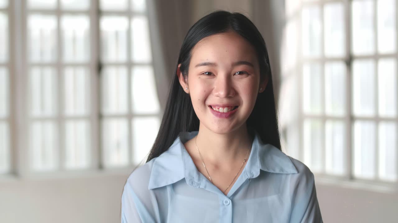 Asian Female Smile And Looking At Camera In Home Living Room, Video In 4K