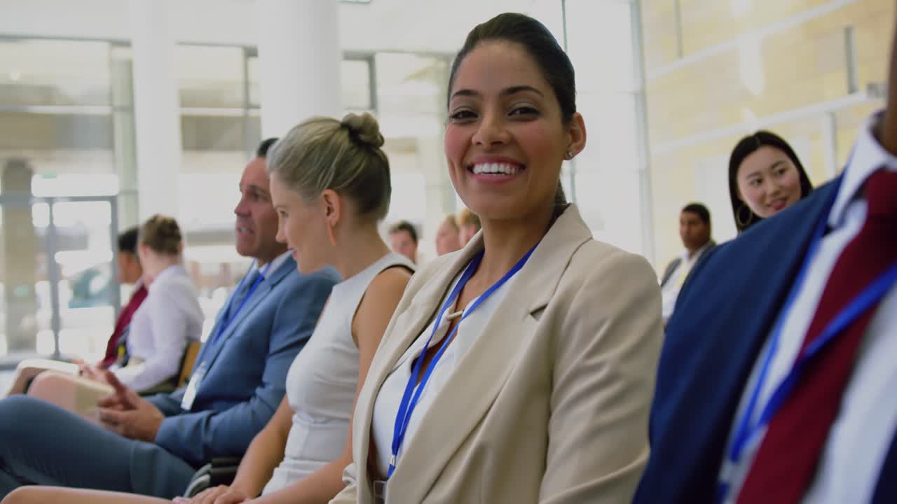 Businesswoman looking at camera during seminar 4k