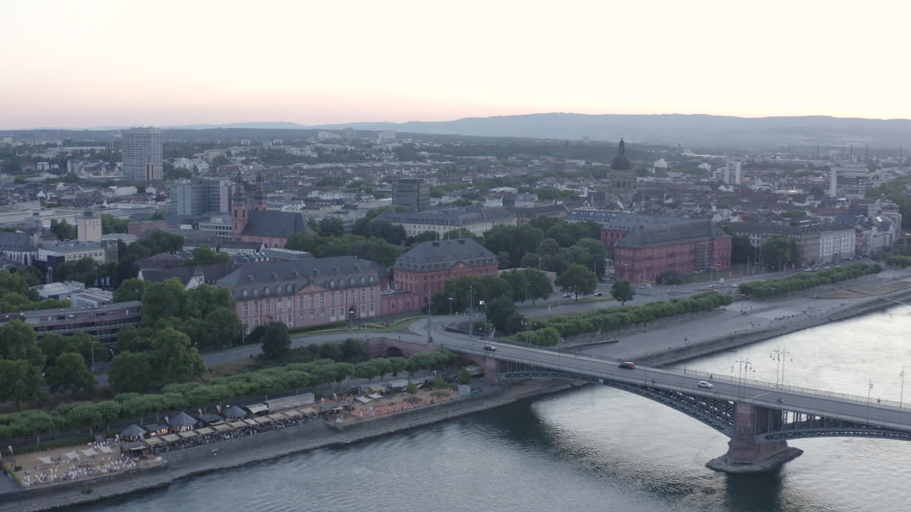 Aerial circling Drone View of Mainz castle Landtag, Christuskirche, river rhine Theodor Heuss Bridge and Cityscape at Sunset Germany 4k