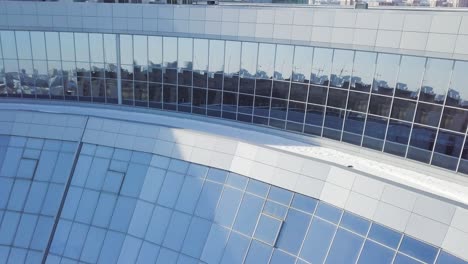 curved glass facade of a modern building in winter