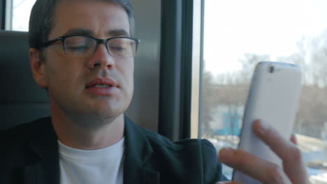businessman talks on skype using smartphone