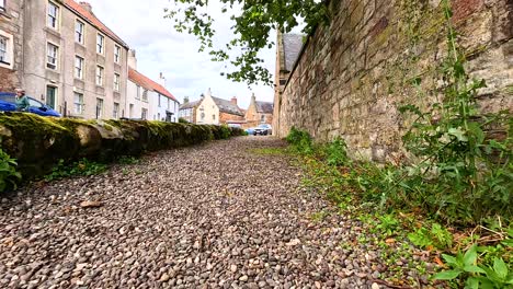 a quiet stone path lined with historic buildings