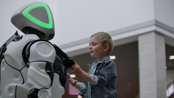Robot umanoide parla con un bambino a una mostra di tecnologia. Il Parco Espositivo dei Robot. Robot umanoide parla con un bambino.