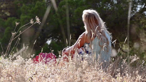 Woman-sitting-in-a-field