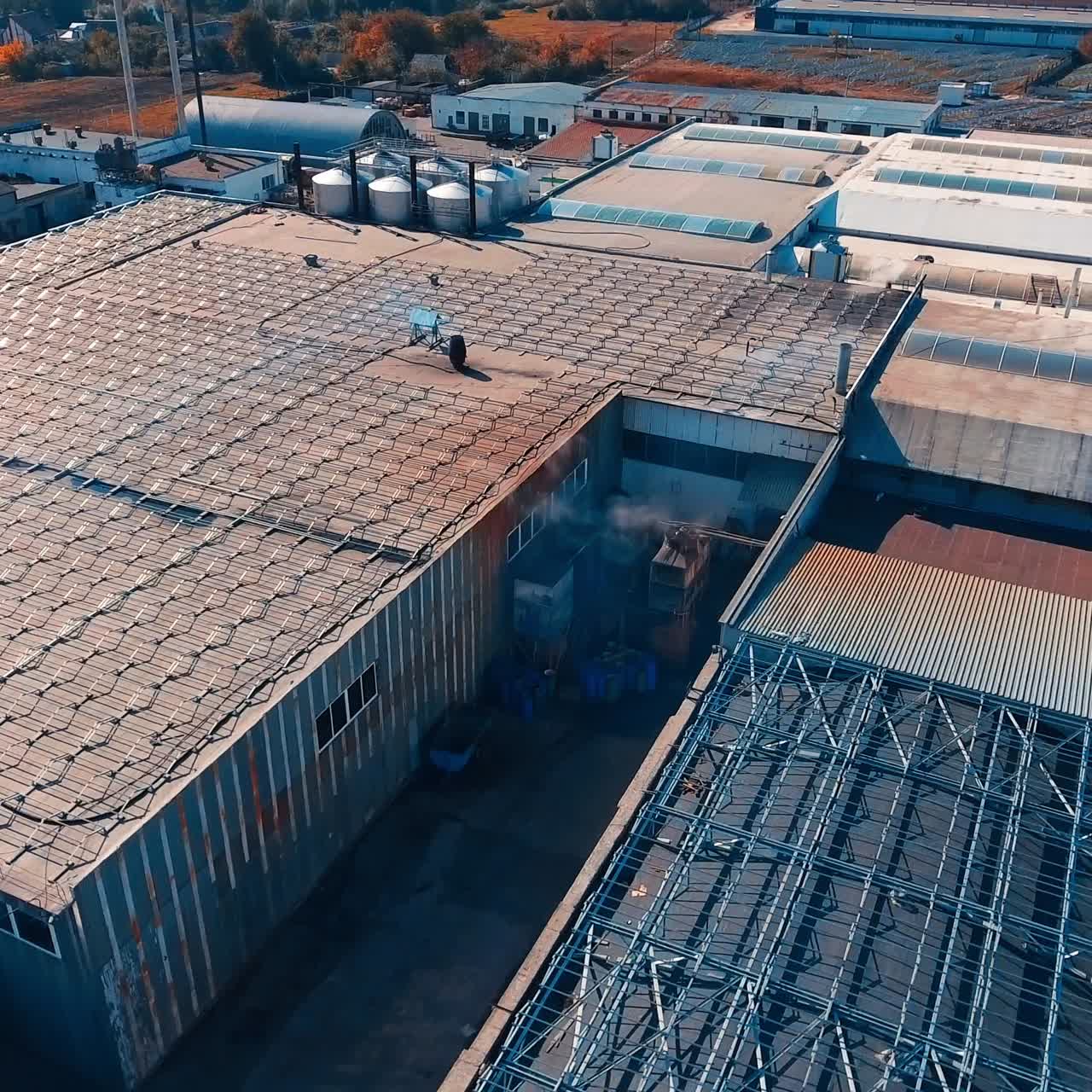 Roofs of storehouses prepared for installing solar panels on. Tops of the hangars covered with metal constructions for sun batteries