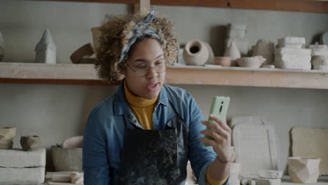 woman demonstrating pottery techniques in online class