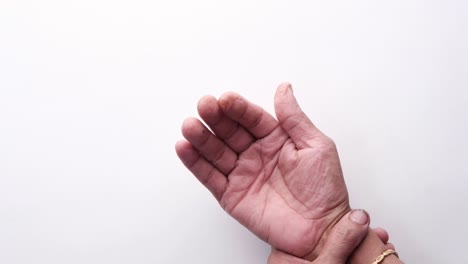 close-up of a person's hand, showing wrinkles and potential joint pain.