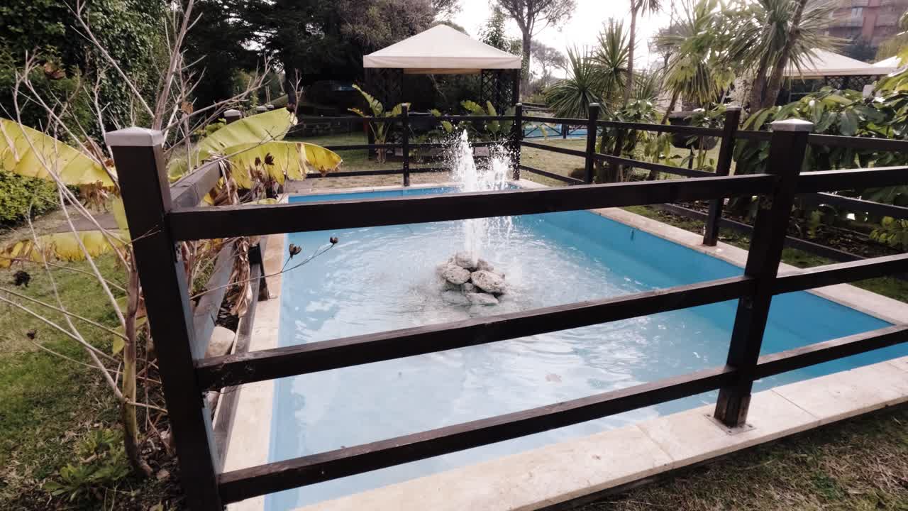 Tranquil garden setting with a scenic pond and decorative fountain in a serene outdoor space