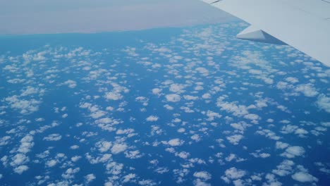 a shot of thousands of tny clouds taken from a plane during the flight