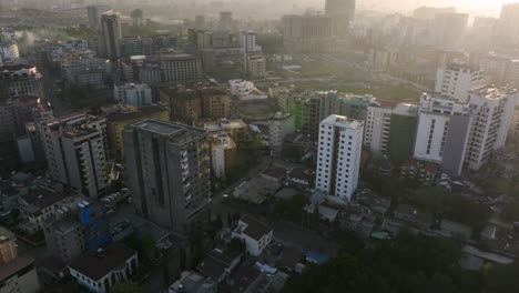 addis ababa city at sunrise with adey abeba international stadium under construction in the distance in ethiopia. - aerial shot