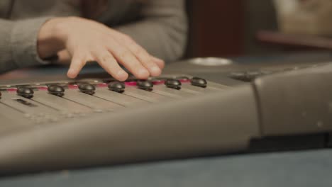 a person adjusting an audio mixer