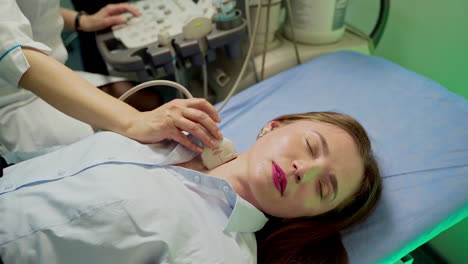 uzi diagnostic on female patient. woman checks her health status in modern clinic. professional doctor is making ultrasound examination to a young woman in hospital.