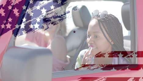 animation of flag of usa over happy diverse women in car by beach in summer