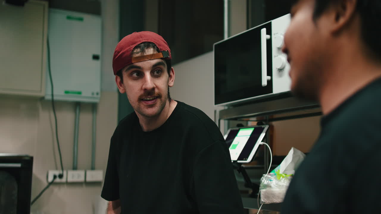 Man wearing a red cap indoors