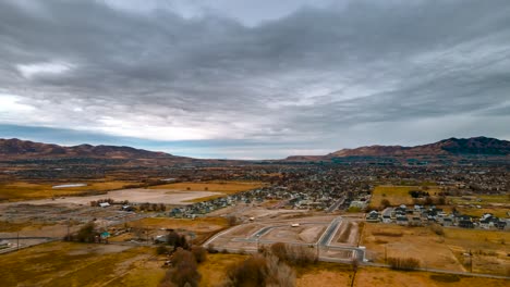 Aerial-hyperlapse-of-a-stormy-cloudscape-and-landscape-being-developed-for-a-housing-suburb